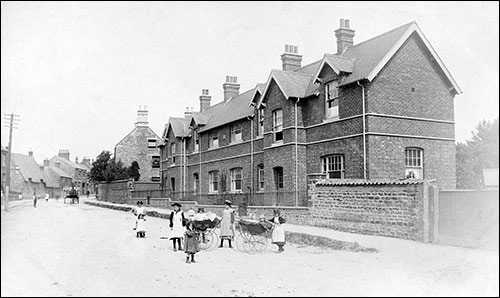 Photograph taken in 1905 showing the Cottage Homes with the stone gable-end of 159 High Street shown to the left of the block