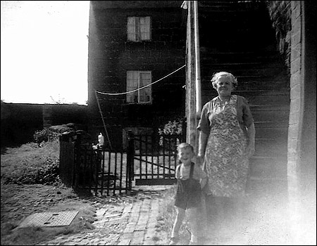 Myself and Great Aunt Annie at the bottom of our stairs, Nan Robinson's house in background 1958
