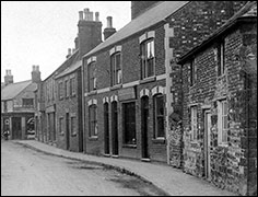 The row of houses and shops on the High Street between Bakehouse Lane and Church Street, before the development of the Co-op