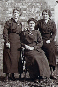 Photograph taken in the early 1900s of three lady workers outside the factory.
