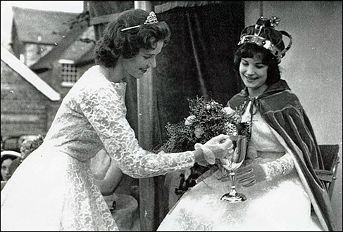 1960 Queen Peggy Hull receives a cup from 1959 Queen Eileen Williamson