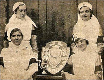 Burton Latimer Nursing Sisters: Seated left Ambulance Officer Mrs Summerfield (leader) and Ambulance Sister Mrs E Clews. Standing Ambulance Sister Miss A Cook and Ambulance Sister Miss M Ashby. 