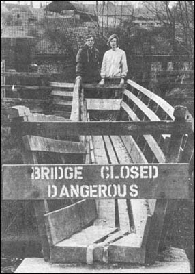 Mr Dicks, clerk of Isham Council & Mrs Evelyn James examine the bridge, 1985
