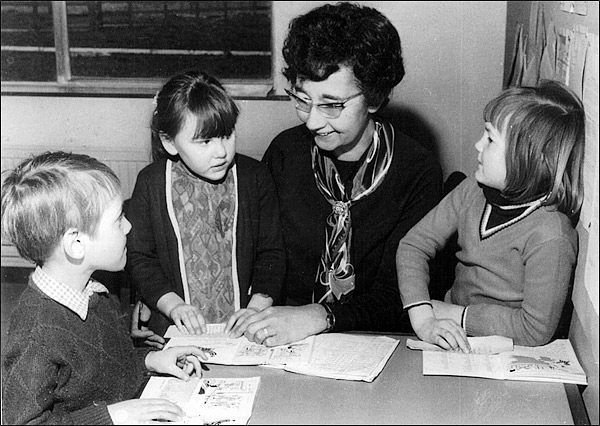 Mrs Peggy Pearson with three children in her class in about 1971
