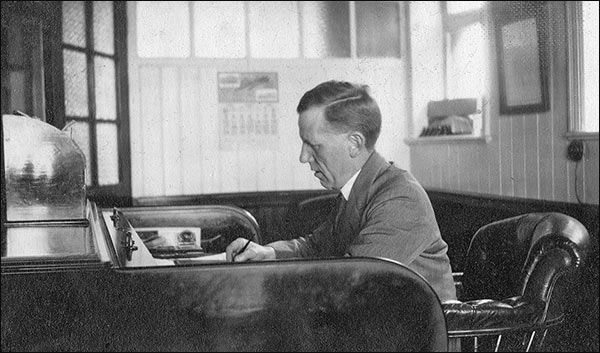 Photograph of Oliver Tailby at his desk in the office