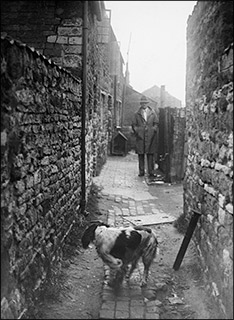 Mr G Borman - the council Surveyor - in the alleyway from the High Street to Wallis' Yard