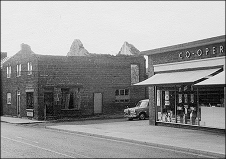 The demolition of the top end of the High Causeway in 1969.  Benford's barber's shop stood opposite the Co-op store
