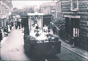 The 1956 Carnival Parade passing Watts' shop in 1 Kettering Road