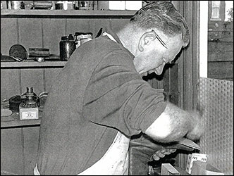 Colin Mason, cobbler, at work. 