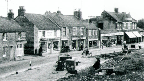 Road widening in 1961 showing the row of shops later to be part of the Co-op.