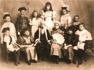 Photograph showing the cast of Cinderella: Standing: LtoR: George Talbutt, Arthur Barlow, Lucy Tailby, Nancy Loveday, Roland Boardman, Alfred Darby.  Seated: L to R: Frank Reynolds, Horace Miller, lJoe Whitney, Lily Blake, Wilf Downing, Frank Downing