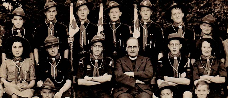 The original Boy Scout Group in 1940.  The adults in the centre of this group include Molly Watson ACM, George Ramsbotton SM, Jack Addis GSM, Rev R W Sharpley (Rector), Ray Basford PL and Edna Addis CM. Behind them are Alan Denley, Roger Saddington, Joe Swann, ?, Edwin Ramsbottom, Norman Law and Maurice Buckby.  