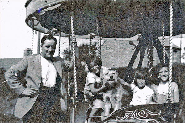 John Strudwick and his roundabout with three of his daughters - 1930s